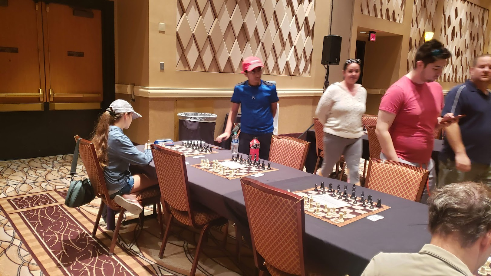 Aaryan playing at a chess tournament hall